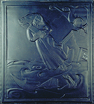 relief carved in slate of a girl floating above a broken boat that is partly visible above the water